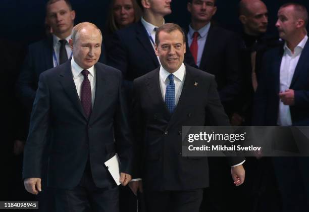 Russian President Vladimir Putin and Prime Minister Dmitry Medvedev enter the hall during the XIX Congress of United Russia Party on November 23,...