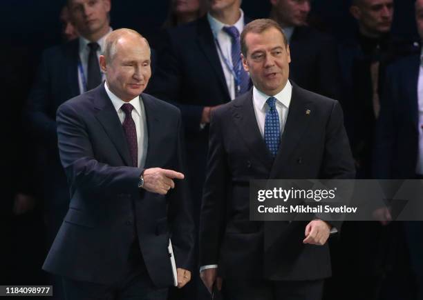 Russian President Vladimir Putin and Prime Minister Dmitry Medvedev enter the hall during the XIX Congress of United Russia Party on November 23,...