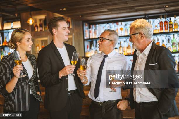 business people having fun talking and discussion with while drinking champagne at business success party. - cocktail party work stock pictures, royalty-free photos & images