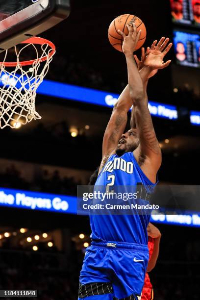 Al-Farouq Aminu of the Orlando Magic drives to the basket in front of defender Damian Jones of the Atlanta Hawks during a game at State Farm Arena on...