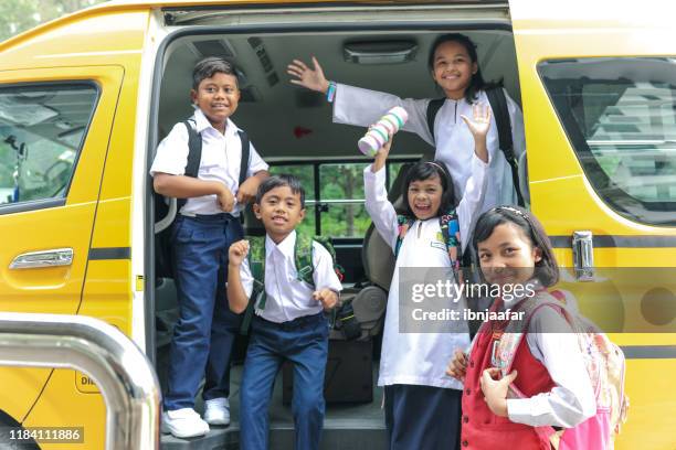 elementary student riding bus to school - malaysia school stock pictures, royalty-free photos & images