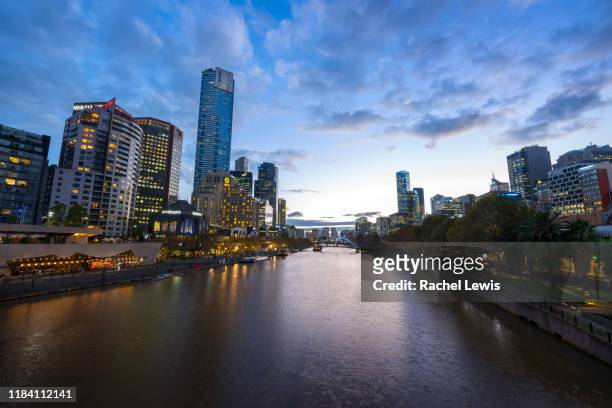 yarra river and melbourne city skyline at dusk - melbourne lights stock pictures, royalty-free photos & images