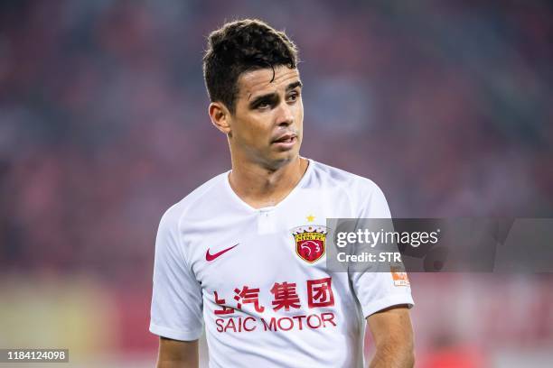 Shanghai SIPG's Oscar looks on during the Chinese Super League football match between Guangzhou Evergrande and Shanghai SIPG in Guangzhou in China's...