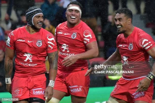 Toulouse's New Zealand centre Pita Ahki celebrates with teammates after scoring a try during the European Champions Cup rugby union pool match...