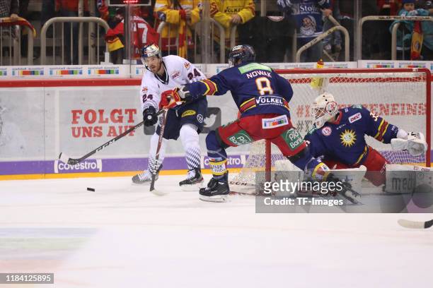 Bobby Sanguinetti of EHC Red Bull Muenchen and Marco Nowak of Dueseldorfer EG battle for the ball during the DEL match between Dueseldorfer EG and...