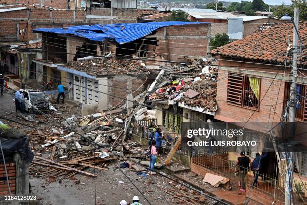People collect their belongings from their houses destroyed by a blast targeting a police station in Santander de Quilichao, Cauca department, on...