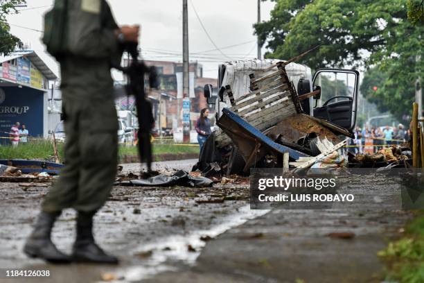 Police officer stands guard at the site of a blast targeting a police station in Santander de Quilichao, Cauca department, on November 23, 2019....