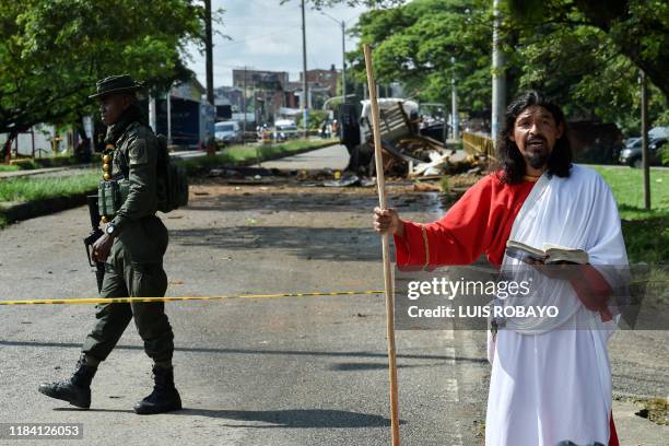 Man prays at the site of a blast targeting a police station in Santander de Quilichao, Cauca department, on November 23, 2019. Three officers were...