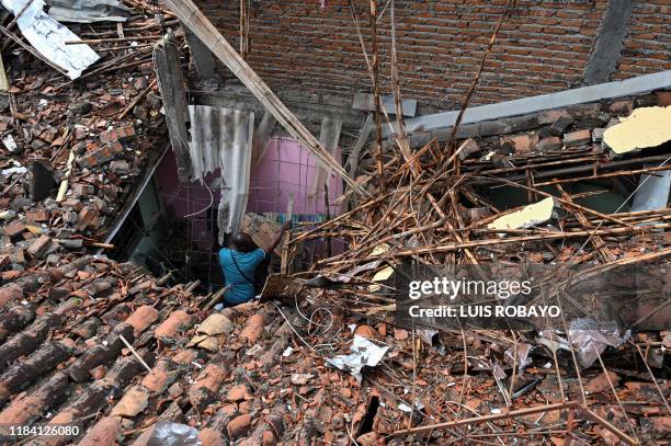 Man checks his house destroyed by a blast targeting a police station in Santander de Quilichao, Cauca department, on November 23, 2019. Three...