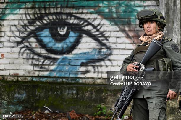 Police officer stands guard at the site of a blast targeting a police station in Santander de Quilichao, Cauca department, on November 23, 2019. -...
