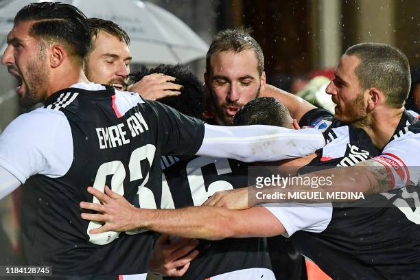 Juventus' Argentinian forward Gonzalo Higuain celebrates with Juventus' German midfielder Emre Can , Juventus' Welsh midfielder Aaron Ramsey and...