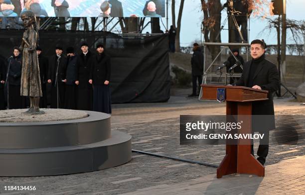 Ukrainian President Volodymyr Zelensky addresses to audience during a commemoration ceremony at a monument of victims of the Holodomor famine of...