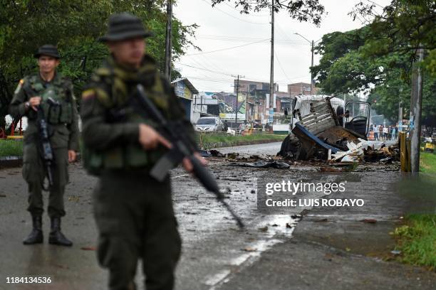 Police officers stand guard at the site of a blast targeting a police station in Santander de Quilichao, Cauca department, on November 23, 2019. -...