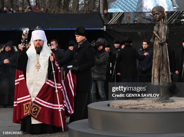 Metropolitan Yepifaniy, the head of the independent Ukrainian Orthodox Church conducts a prayer during a commemoration ceremony at a monument to...