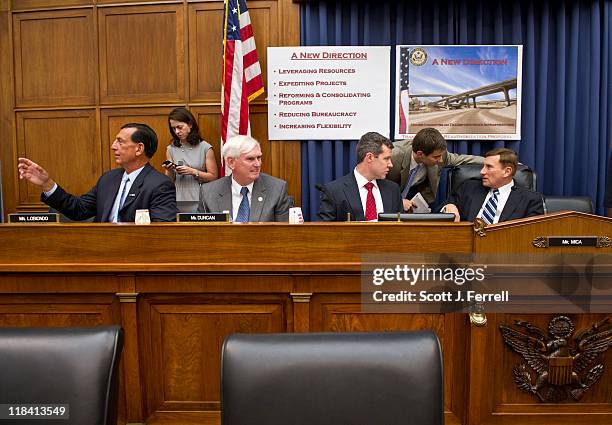 July 07: House Transportation Chairman John L. Mica, R-Fla., far right, talking with aides, before a news conference introducing the Republican...