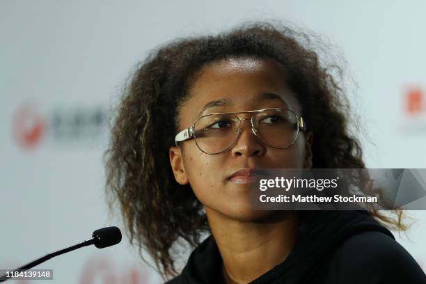 Naomi Osaka of Japan fields questions from the media during a press conference after withdrawing from the tournament due to a right shoulder injury...