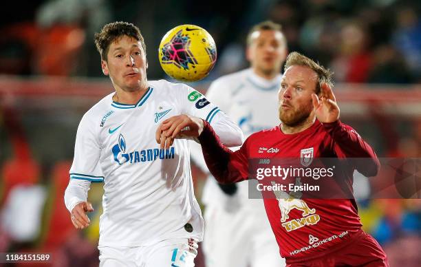 Vitaliy Denisov of FC Rubin Kazan and Daler Kuzyayev of FC Zenit Saint Petersburg vie for the ball during the Russian Football League match between...