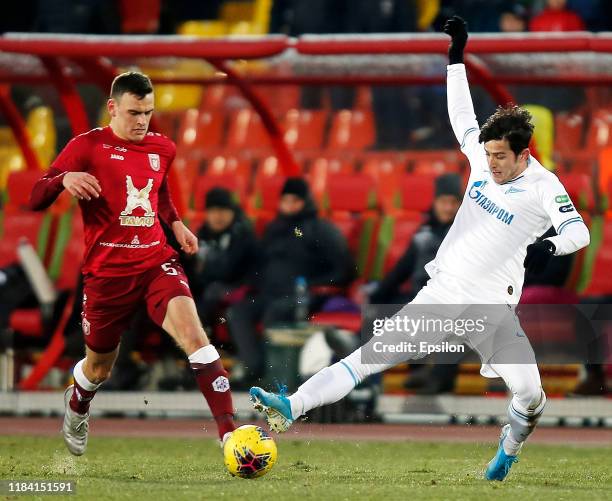 Filip Uremovic of FC Rubin Kazan and Sardar Azmoun of FC Zenit Saint Petersburg vie for the ball during the Russian Football League match between FC...