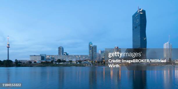 donaucity with danube tower and pwc tower on the danube, blaue stunde, vienna, austria - donauturm stock pictures, royalty-free photos & images