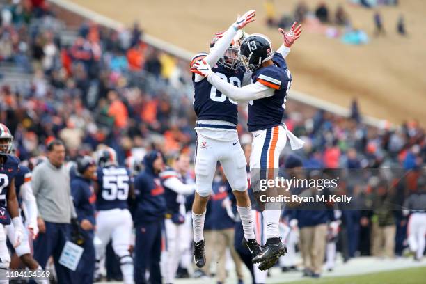 Hayden Mitchell and Terrell Jana of the Virginia Cavaliers celebrate a touchdown in the first half during a game at Scott Stadium on November 23,...