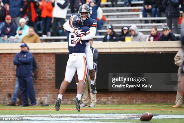 Lamont Atkins and PK Kier of the Virginia Cavaliers celebrate a touchdown in the first half during a game against the Liberty Flames at Scott Stadium...