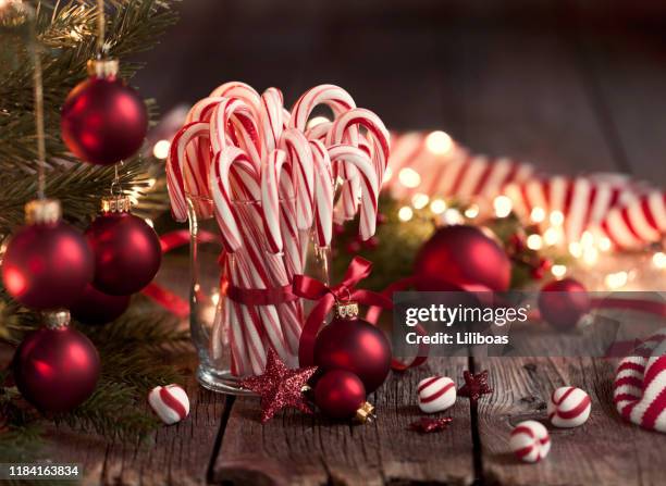 candy canes and bright christmas lights - candy cane stock pictures, royalty-free photos & images