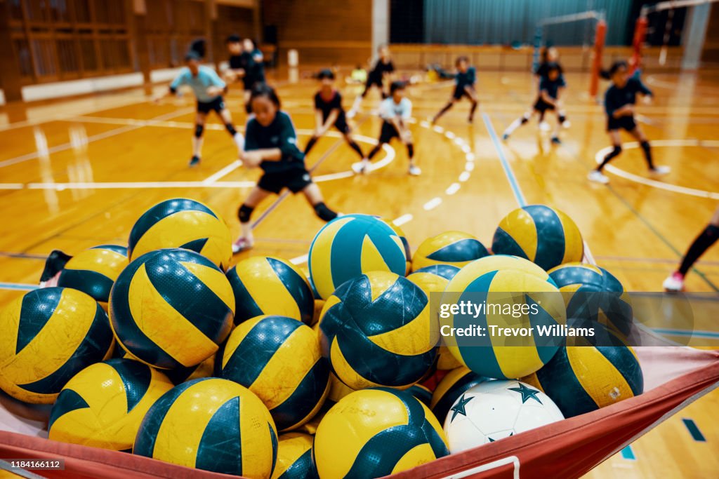 Young girls warming up during a team volleyball practice