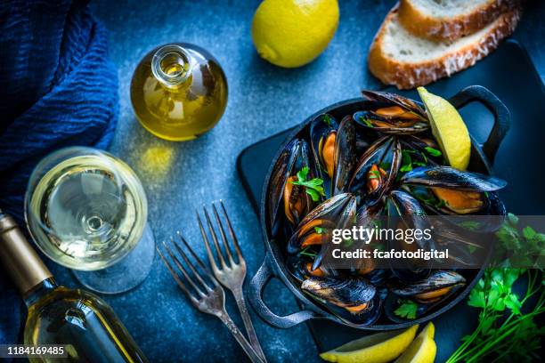 steamed mussels and white wine - iron wine stock pictures, royalty-free photos & images