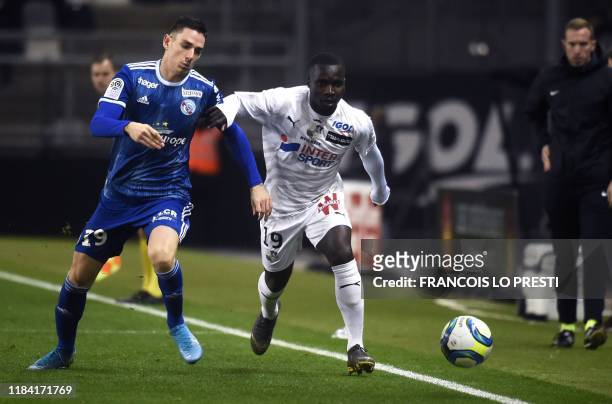 Amiens' Congolese forward Chadrac Akolo vies for the ball with Strasbourg's French defender Anthony Caci during the French L1 football match between...