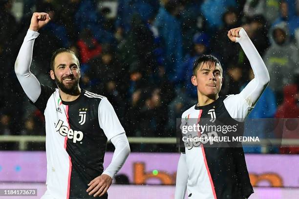 Juventus' Argentine forward Paulo Dybala celebrates with Juventus' Argentinian forward Gonzalo Higuain after scoring his team's third goal during the...