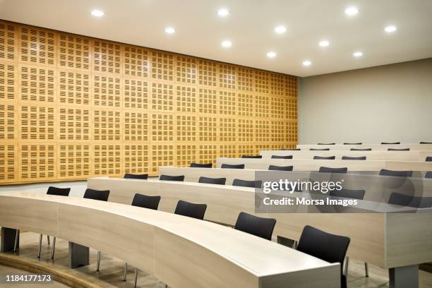 interior of empty illuminated lecture hall - empty classroom stock pictures, royalty-free photos & images