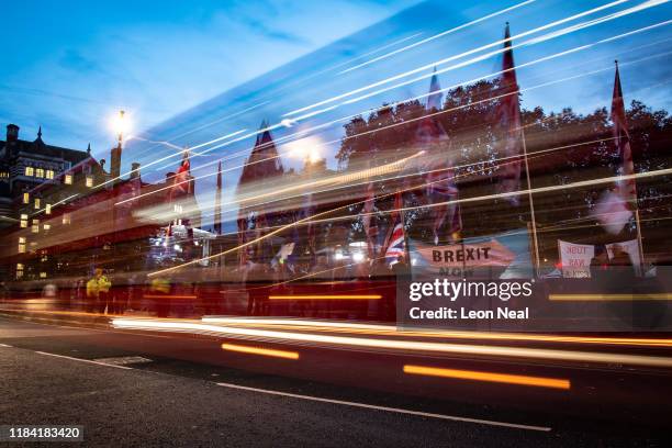 Supporters and critics of Brexit are seen through the trails of car lights as they protest opposite the Houses of Parliament on October 29, 2019 in...