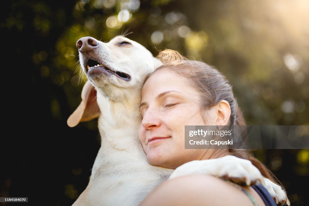 Woman hugging her dog