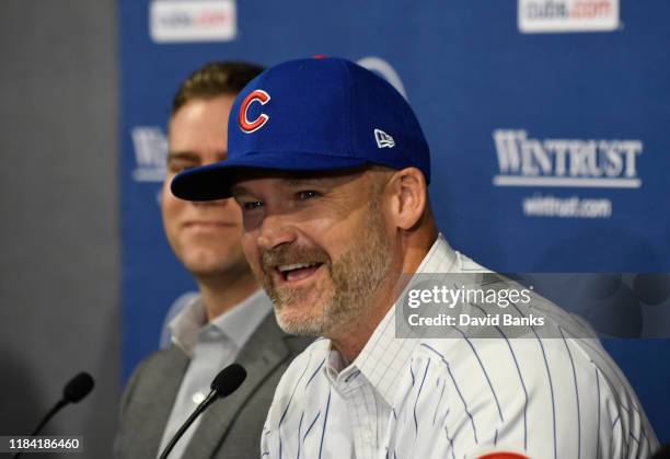 Theo Epstein, president of baseball operations of the Chicago Cubs looks on as David Ross, new manager of the Chicago Cubs talks to the to the media...