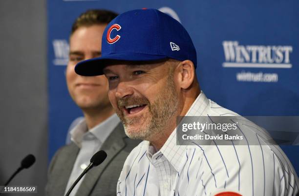 Theo Epstein, president of baseball operations of the Chicago Cubs looks on as David Ross, new manager of the Chicago Cubs talks to the to the media...