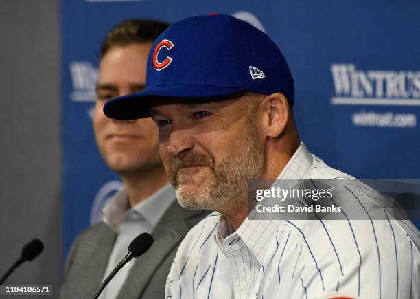 Theo Epstein, president of baseball operations of the Chicago Cubs looks on as David Ross, new manager of the Chicago Cubs talks to the to the media...
