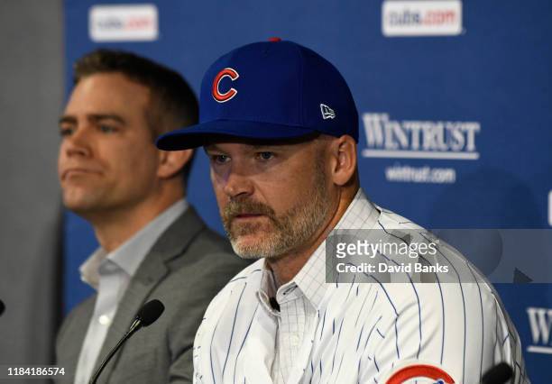 Theo Epstein, president of baseball operations of the Chicago Cubs looks on as David Ross, new manager of the Chicago Cubs talks to the to the media...