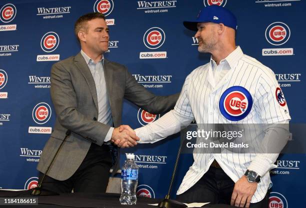 Theo Epstein, president of baseball operations of the Chicago Cubs shakes hands with David Ross, new manager of the Chicago Cubs talks to the to the...