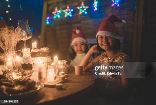 2 asian chinese children waiting for their dinner served during christmas party - children only stock pictures, royalty-free photos & images