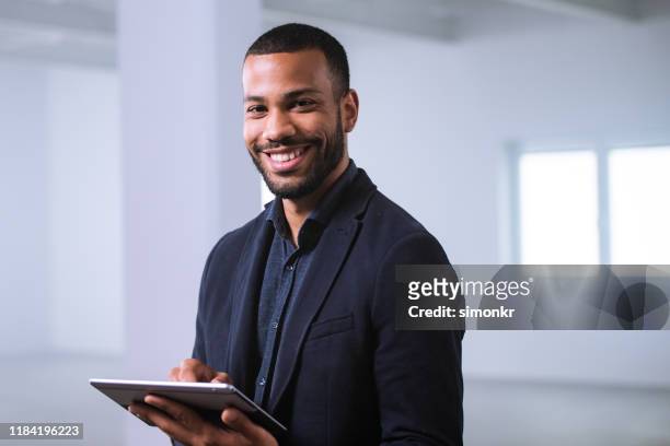 businessman using digital tablet - black businessman stock pictures, royalty-free photos & images