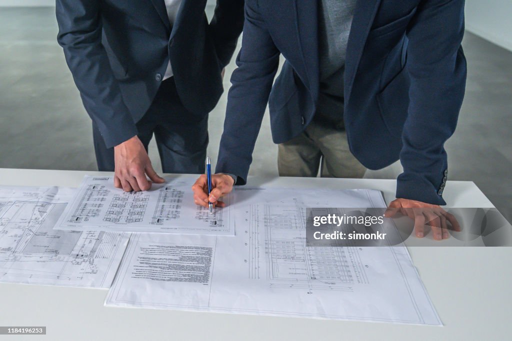 Blueprint Discussion Businessmen Discussing Blueprint High-Res Stock Photo - Getty Images
