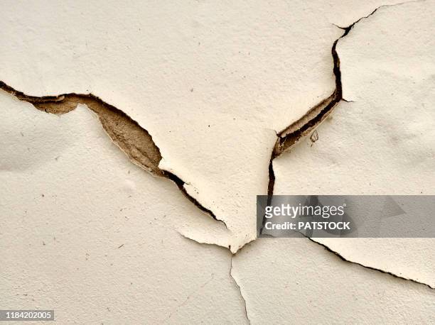 cracked wall, plaster peeling off the wall - cracked plaster stock pictures, royalty-free photos & images