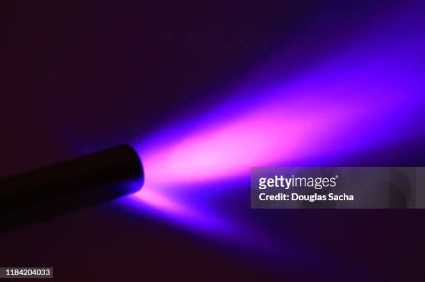 illuminated black light with from a ultraviolet flashlight - uv light stock pictures, royalty-free photos & images