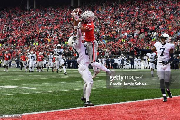 Chris Olave of the Ohio State Buckeyes makes the catch for a 28-yard touchdown pass over John Reid of the Penn State Nittany Lions in the fourth...