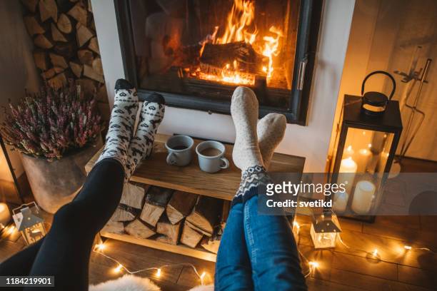 winter day by fireplace - cosy stock pictures, royalty-free photos & images