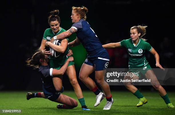 Louise Galvin of Ireland is tackled by Alev Kelter of USA and Stephanie Rovetti of USA during the Rugby X at The O2 Arena on October 29, 2019 in...