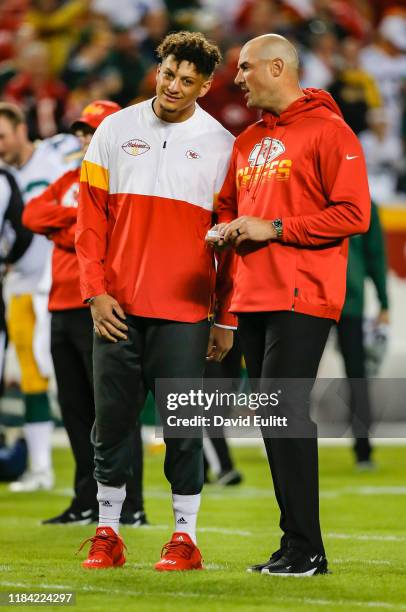 Patrick Mahomes of the Kansas City Chiefs speaks to Chiefs quarterbacks coach Mike Kafka, right, prior to the game against the Green Bay Packers at...