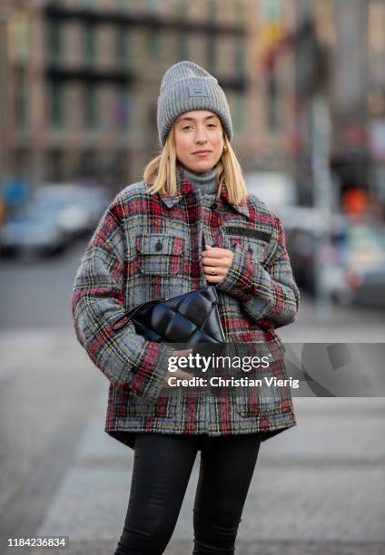 Sonia Lyson is seen wearing black pants Zara, cashmere turtleneck, Bottega Veneta bag, grey red plaid jacket Lala Berlin, grey beanie Acne on October...