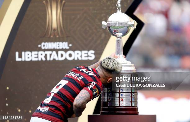 Flamengo's Gabriel Barbosa kisses the trophy after winning the Copa Libertadores final football match by defeating Argentina's River Plate, at the...