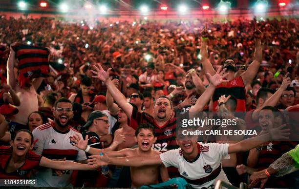 Fans of Brazil's Flamengo react after their team defeated Argentina's River Plate in the Copa Libertadores football final, during the match...